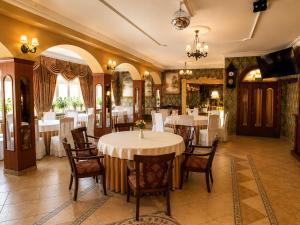a dining room with white tables and chairs at Pensjonat Angela in Łeba +48 photos