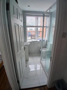 a bathroom with a shower and a glass door at Connolly station homestay in Dublin
