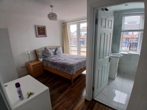 a small bedroom with a bed and a window at Connolly station homestay in Dublin