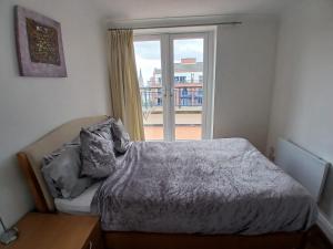 a bedroom with a bed and a large window at Connolly station homestay in Dublin