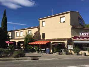 a building with a hotel on the side of the street at La Bastide in Mallemort
