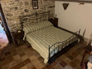 a bed in a room with a stone wall at Il Convento di Roberta in Civitanova del Sannio