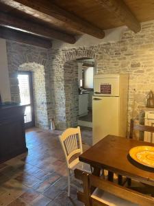 a kitchen and dining room with a table and a refrigerator at Il Convento di Roberta in Civitanova del Sannio