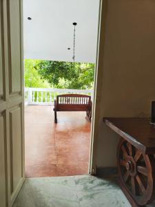 a door leading to a porch with a bench in a room at AUM VILLA Homestay in Pondicherry and Auroville in Puducherry Airpoert