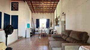 a living room with a couch and a table at Casa Marina in Beberibe