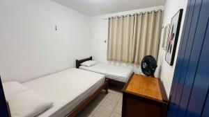 a small room with two beds and a fan at Casa Marina in Beberibe +36 photos
