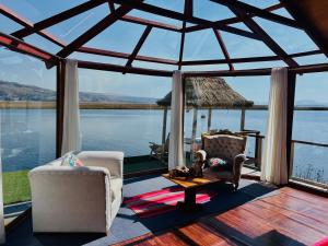a living room with a view of the water at Titikala in Puno