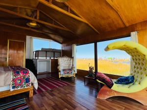 a bedroom with a bed and a large window at Titikala in Puno