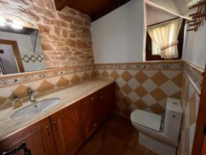 a bathroom with a sink and a toilet at Casa Menta in Pomar de Valdivia +27 photos