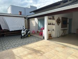 a motorcycle parked on a patio next to a house at Casa do Pedrão in Eunápolis