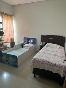 a bedroom with a bed with stuffed animals on it at Casa do Pedrão in Eunápolis +5 photos