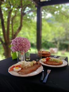 a black table with two plates of food on it at Complejo La Cascada San Javier in San Javier