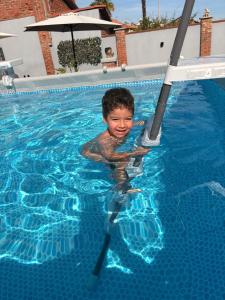 a young boy is in a swimming pool at Lore Sole in Caluso