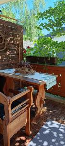 a wooden table and a bench on a patio at Ferienwohnung Eckschlager in Kössen