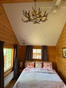 a bedroom with a bed and a chandelier at Villa Wanda in Savonlinna