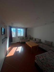 a living room with a couch and a coffee table at Residence Jamal Only Family in Martil