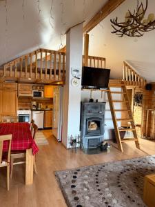 a living room with a table and a stove at Villa Wanda in Savonlinna