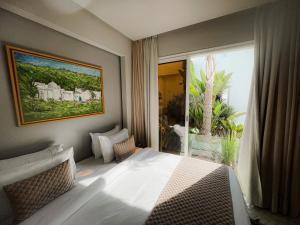 a bedroom with a bed and a large window at Riad Zyo in Rabat +177 photos