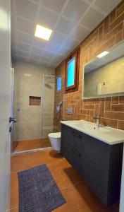 a bathroom with a sink and a toilet and a shower at Bozburunvillas in Bozburun +15 photos