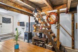 a room with a wooden floor and a wooden ladder at The Caravel Apúlia in Apúlia
