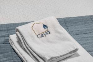 a towel on a bed with a comforter on it at The Caravel Apúlia in Apúlia +46 photos