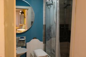 a bathroom with a shower and a sink at The Little Hatbox in Newburgh