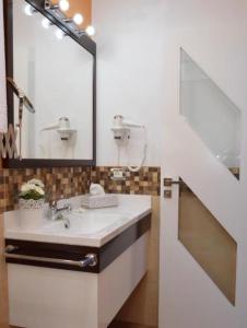 a bathroom with a sink and a mirror at Hotel Drago San Antonio in Icod de los Vinos +52 photos