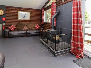 a living room with a couch and a fireplace at The Roe in St Asaph