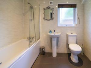 a bathroom with a toilet and a sink and a shower at The Roe in St Asaph +35 photos