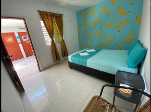 a bedroom with a bed with bananas on the wall at Tamarindo in Santa Marta