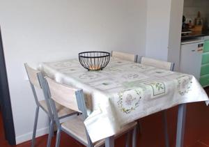 a kitchen table with a white table cloth on it at Villa Visconde in Nordeste +19 photos