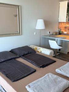 a room with two beds and a mirror on the wall at Balchik Sea View Studio in Balchik +33 photos
