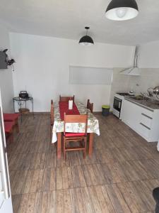 a kitchen and dining room with a table and chairs at Lusanyun3 in Villa Parque Siquiman