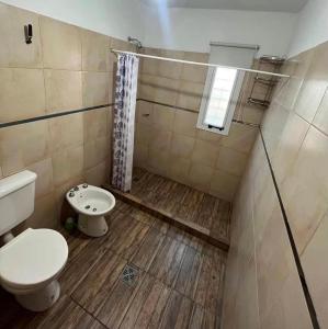 a bathroom with a toilet and a shower at Lusanyun3 in Villa Parque Siquiman