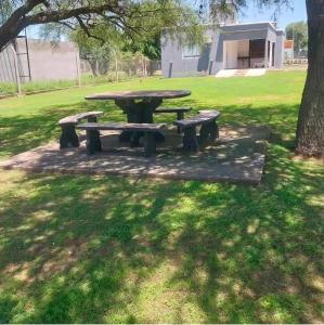 a picnic table and benches in a park at Lusanyun3 in Villa Parque Siquiman