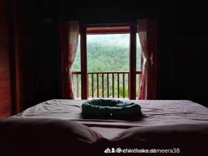 a room with a bed and a window with a view at Wishparing fall villa laxapane in Kiriwan Eliya
