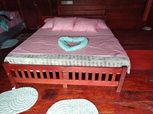 a bed with a blue rope on top of it at Wishparing fall villa laxapane in Kiriwan Eliya +6 photos