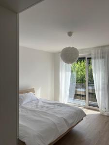 a bedroom with a bed and a large window at Prenočišče Henrik in Dolenjske Toplice