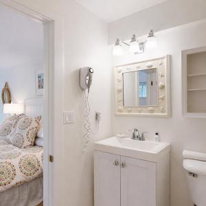 a bathroom with a sink and a mirror at The Trellis House in Ogunquit +43 photos