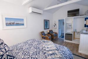 a bedroom with a bed and a living room at The Trellis House in Ogunquit