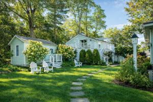 a yard with white houses and a pathway at The Trellis House in Ogunquit