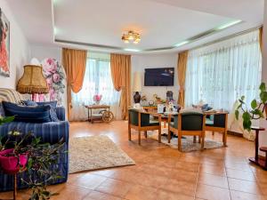 a living room with a table and a dining room at Pensiunea Emma in Sâmbăta de Sus