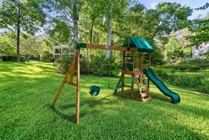 a playground with a slide in a yard at The Sinclair House Private Lake Retreat in Milledgeville