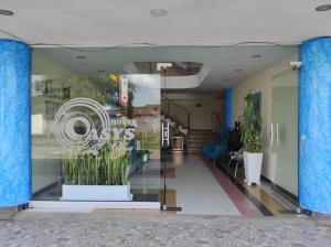 a glass window of a store with a sign on it at Hotel Oasys Blue in Roldanillo