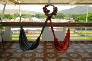 two hammocks hanging in a room with a view at Hotel Oasys Blue in Roldanillo