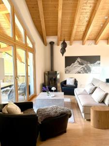 a living room with a couch and a table at Victoria's Home - luxurious penthouse in Saas-Fee