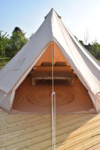 a white tent with a bed in the middle at Tente Inca in Ambillou-Château