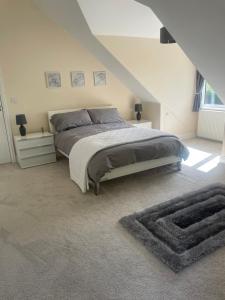 a bedroom with a large bed in a attic at The Croft in Sandhurst