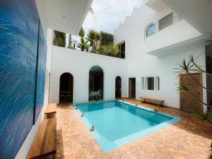 a swimming pool in the middle of a house at Riad Zyo in Rabat