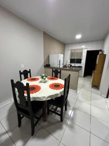 a dining room table and chairs in a kitchen at Lar doce lar in Barra do Garças